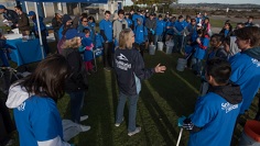 A crowd of people at a SeaWorld event wearing blue
